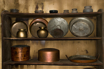 Antique kitchenware collection on wooden shelf, Metal utensils ,pans, containers ,pots made of...