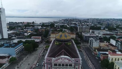 A zoom out shot of roof details of the Amazon theater (Portuguese: Teatro Amazonas) with blue cloudy sky, opera house located in Manaus