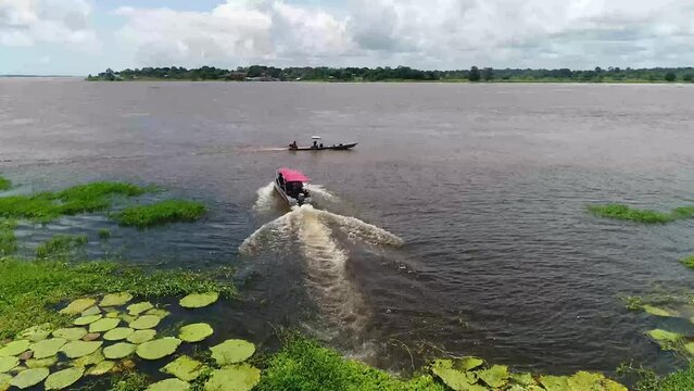 A drone shot over the Amazon river near Parintins, Brazil. Few boats are seen running on the river
