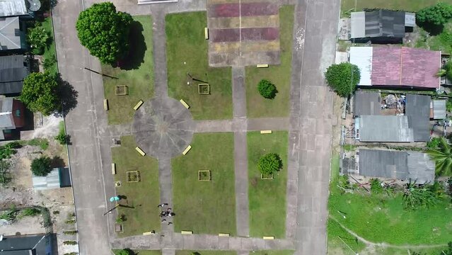 A zoom in shot of center in the city of parintins. An amazing view of a garden captured by drone