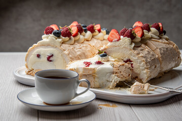 Delicate and airy meringue cake on a plate on the table.