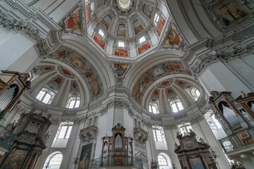 Fototapeta premium Inside undershoot of a dome of Salzburg Cathedral with paintings and golden frames