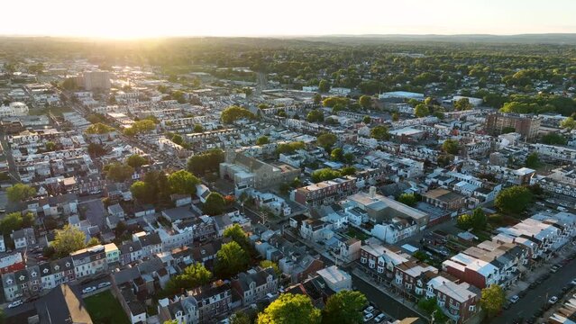 High aerial view of American city during sunset golden hour light. Colorful warm scene.