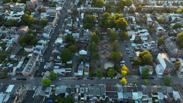 Downtown urban city in USA. Aerial during dramatic sunset tilt up reveal. American lifestyle establishing shot.