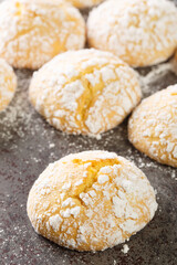 Cracked Lemon cookies with powdered sugar closeup on table. Vertical