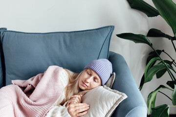 Unhappy Young woman wearing warm clothing sleeping at home. Energy crisis in Europe due to inflation and war. Increase in the price of natural gas for home heating