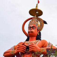 Big statue of Lord Hanuman near the delhi metro bridge situated near Karol Bagh, Delhi, India, Lord Hanuman big statue touching sky - obrazy, fototapety, plakaty