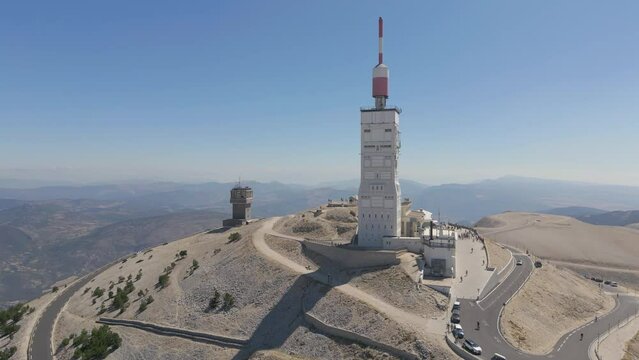 Orbit drone shot around The tower of Mont Ventoux from the North-East face during summer