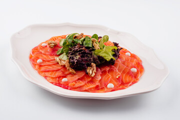Salmon carpaccio with salad on plate