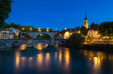 Image of historical bridges on the Aare River in Bern, capital city of Switzerland, during twilight blue hour.