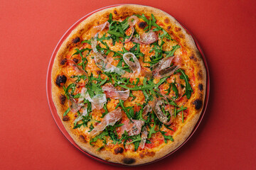 Prosciutto pizza or pinza with arugula in roman style