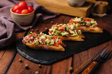 Bruschetta with avocado and tomato closeup