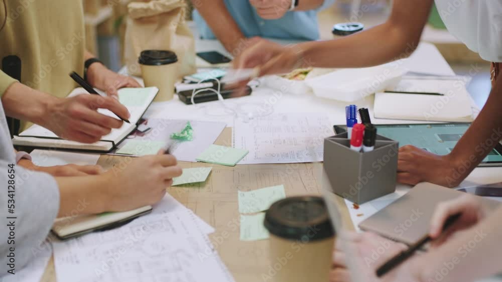 Poster Hands, teamwork and planning with design or business people working as a team in a startup office. Creative, strategy and collaboration with a group at work on an idea with writing and communication