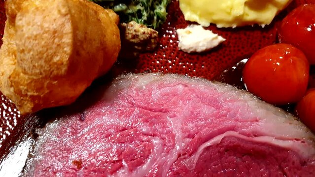 Slice of medium rare roasted beef steak with gravy pudding spinach mashed potato