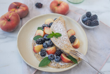 Crepes, thin pancakes or blini with berries