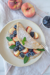 Crepes, thin pancakes or blini with berries