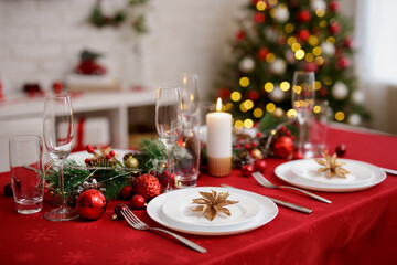 Beautiful table with plates and champagne glasses for family christmas dinner