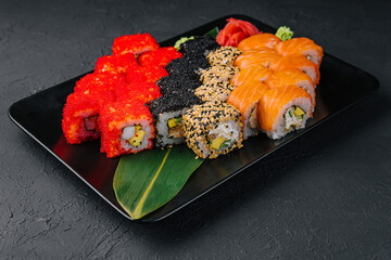 Big set of rolls on black tray