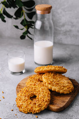 cookies with nut chips and a glass of milk with a bottle