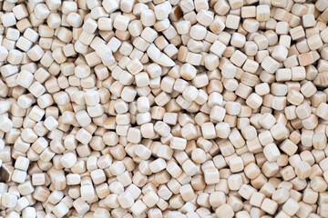 A plenty of small wooden cubes are full filled in a kid playground area for the child's background.