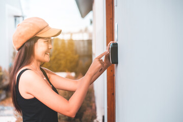 Woman hands pressing to digital door lock security systems at home