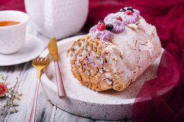 Meringue roll pavlova cake with cream and berries