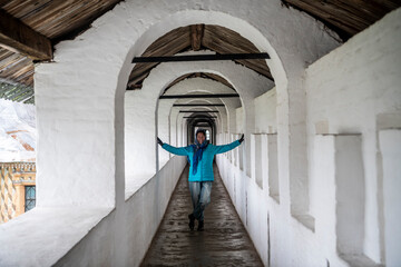 a woman tourist on an autumn day against the backdrop of the sights of the city of Rostov the Great