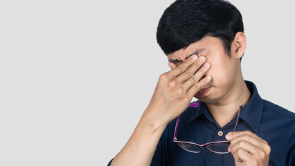 Close up young businessman tried from working gesture take off glasses isolated