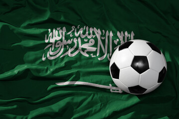vintage football ball on the waveing national flag of saudi arabia background. 3D illustration