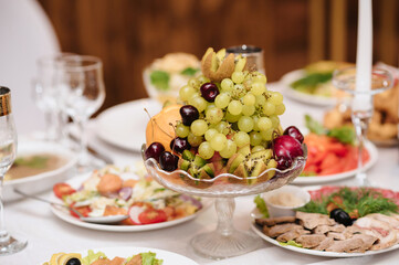 festive table with glasses and food on the table in the restaurant
