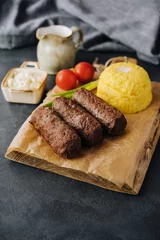 Foto op Canvas Traditional romanian grilled dish - mici or mititei © AntAlexStudio