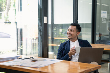 Portrait business man using laptop computer on work desk at office.