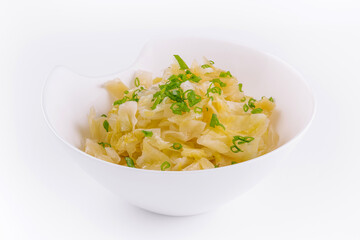 Bowl of tasty fermented cabbage on white