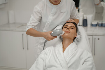 Professional cosmetologist is making cavitation rejuvenation skin treatment. Radio wave lifting