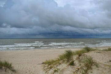 Sand dunes and sea in stormy weather.