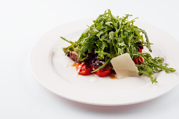 Italian beef tagliata salad with wild rocket, cherry tomatoes and parmesan cheese