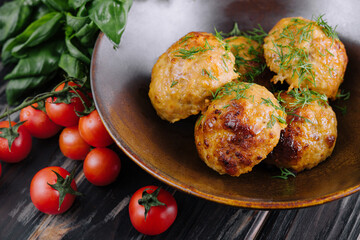 Fried meatballs decorated with salad and tomatoes - obrazy, fototapety, plakaty