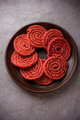 Beatroot chakli, murukku, Beetroot chakli, a spiral fried snack from India made in Diwali festival