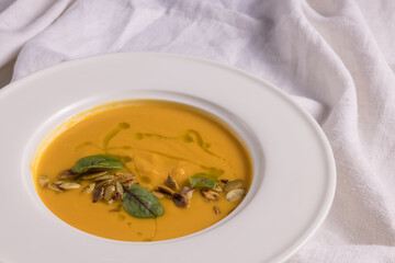 pumpkin soup on a light background, healthy food concept