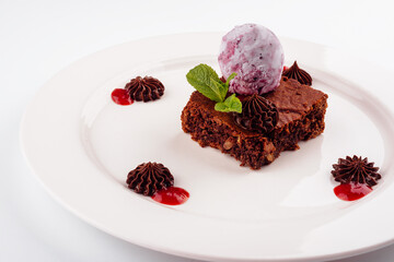 Tasty chocolate brownie with blueberry ice cream