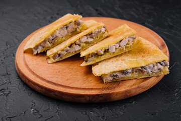 chicken, mushroom and cheese Quesadilla on wooden board