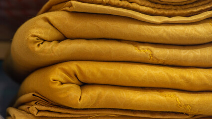 Obraz premium Close up of colorful bed sheet textile. stack of clean bed sheet with different pattern