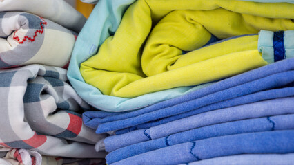 Close up  of colorful bed sheet textile. stack of clean bed sheet with different pattern