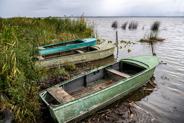 boats for fishing on the lake on a cloudy autumn day