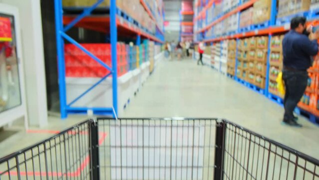 4K : Time lapse of shopping cart moving through supermarket. Various Items and Convenience Food. Hyperlapse in supermarket. commercial concept
