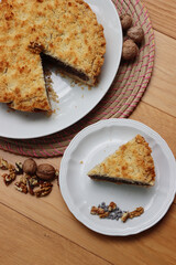 Traditional italian cake Sbrisolona cut in slices made with walnuts and chocolate on a plate on wooden table