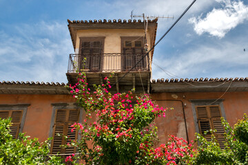 Windows with wooden shutters on facade of old Mediterranean house