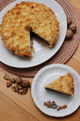 Traditional italian cake Sbrisolona cut in slices made with walnuts and chocolate on a plate on wooden table