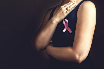 October is breast cancer awareness month,a woman holds a pink ribbon to support people living and sick.Health, international women's day and the concept of the world day of fight against cancer.Noise