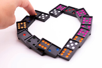 Connect black dominoes to form a heart.heart for love,Valentine's Day.